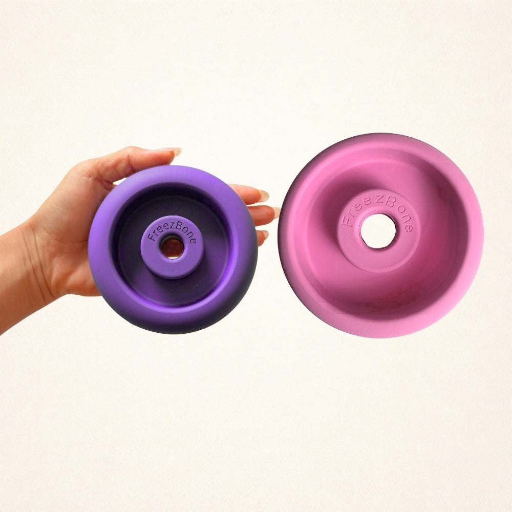 Purple FreezDoughnut held in a hand next to a pink FreezDoughnut