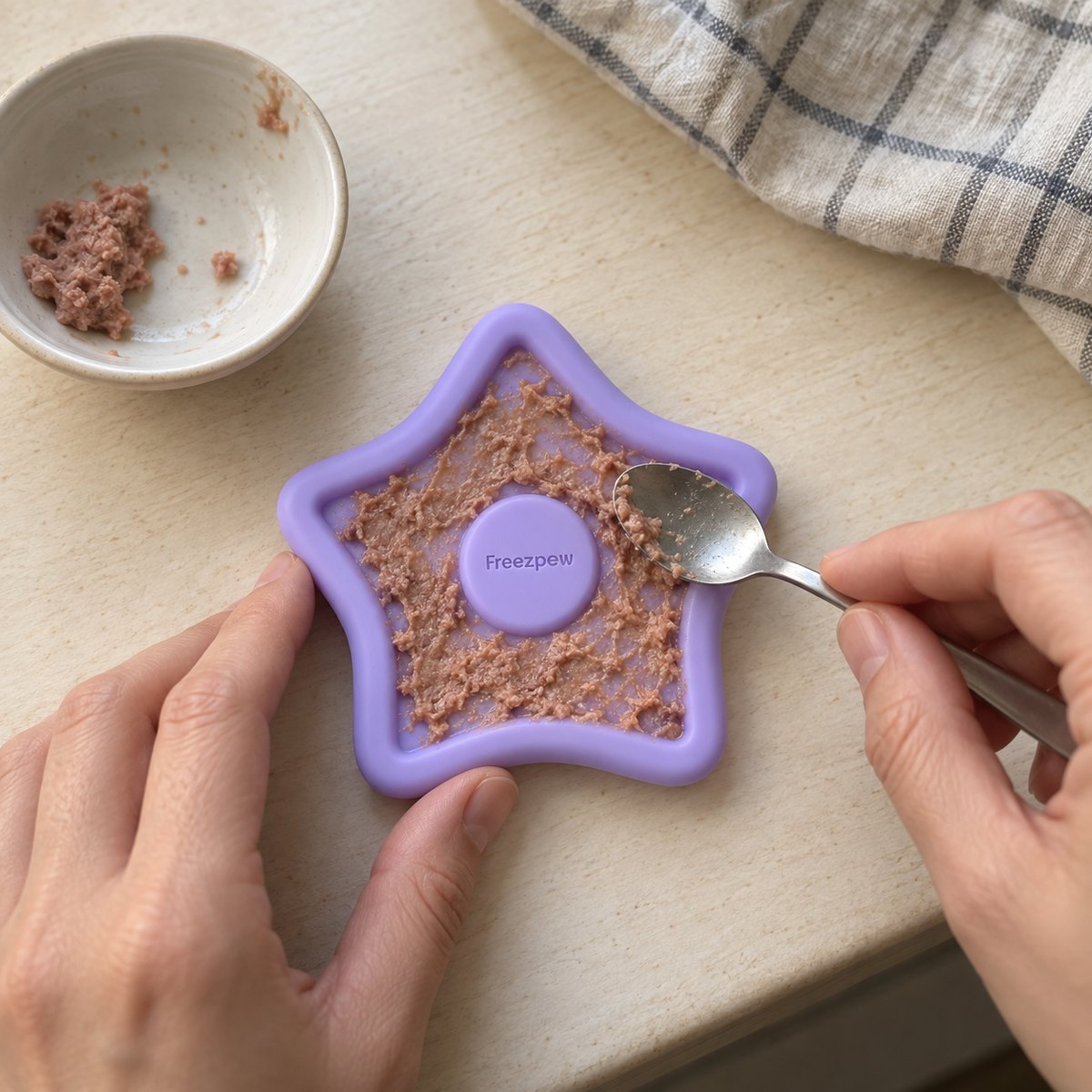 Filling a FreezTwinkle  with a soft treat